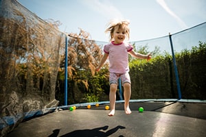 Child jumping on trampoline